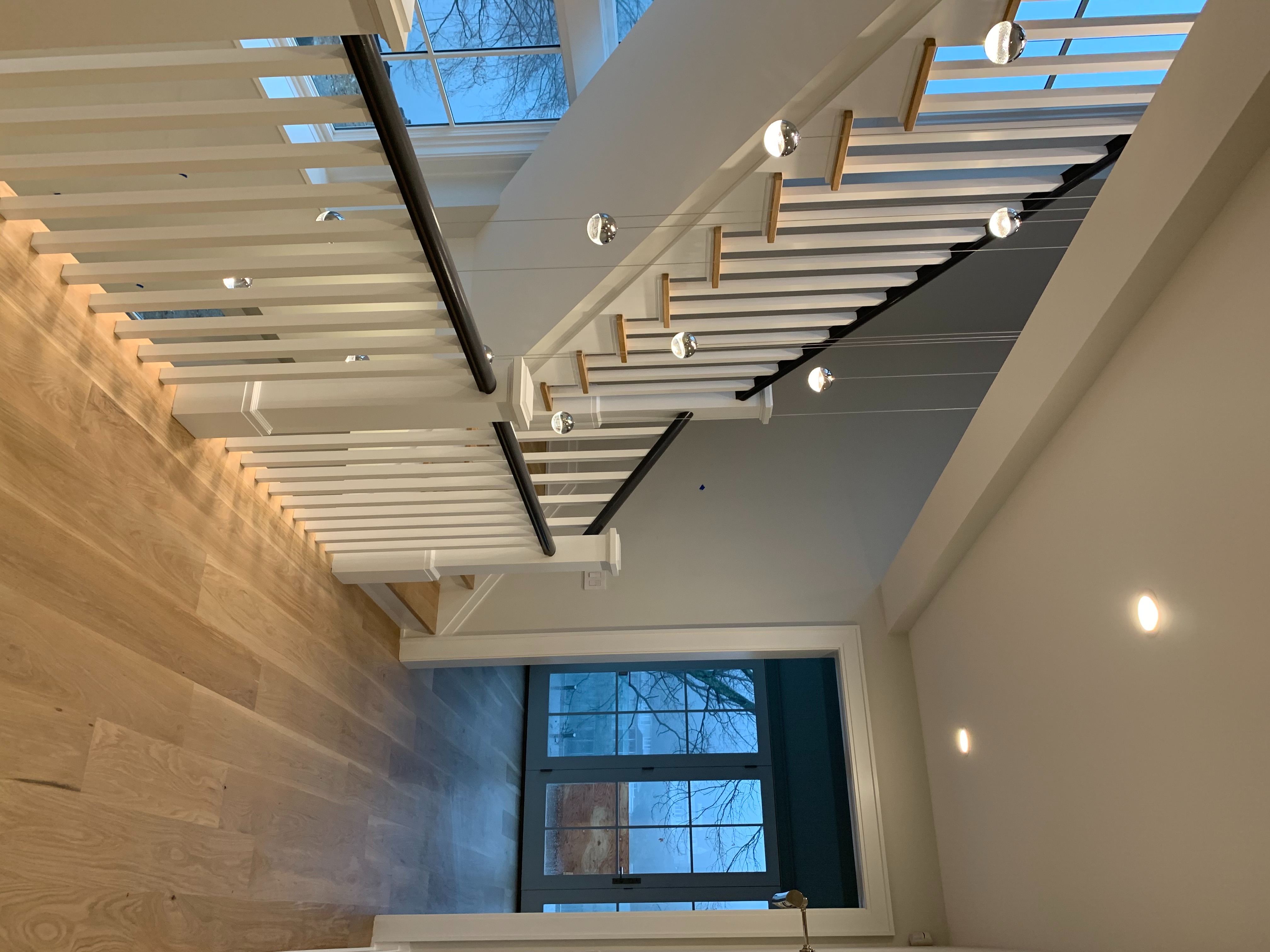 A Staircase With White Railings And Wood Floors