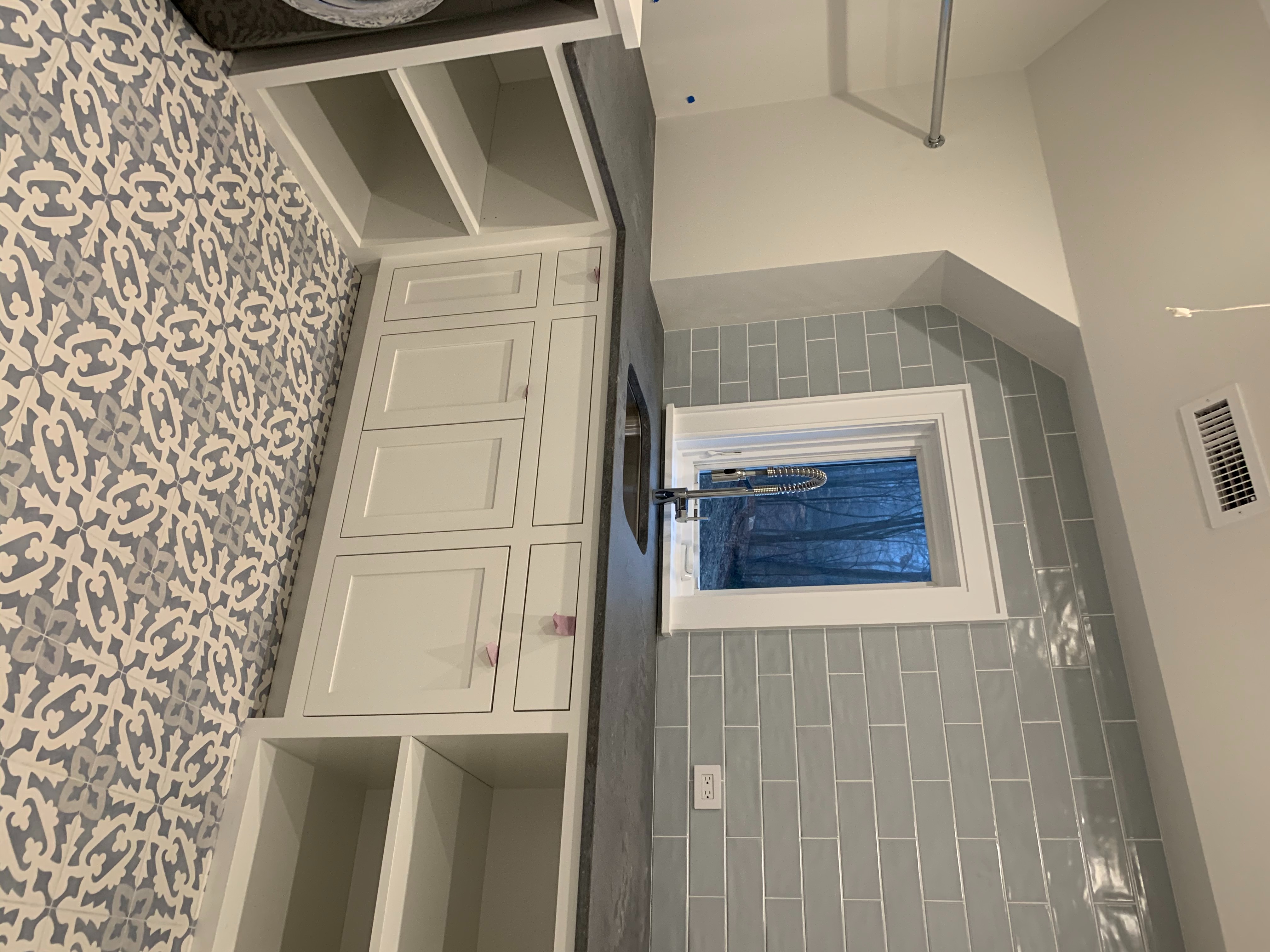 A Kitchen With A Sink And A Window