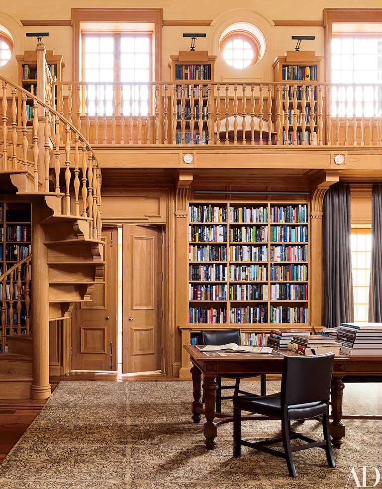 A Library With A Spiral Staircase And Bookshelves