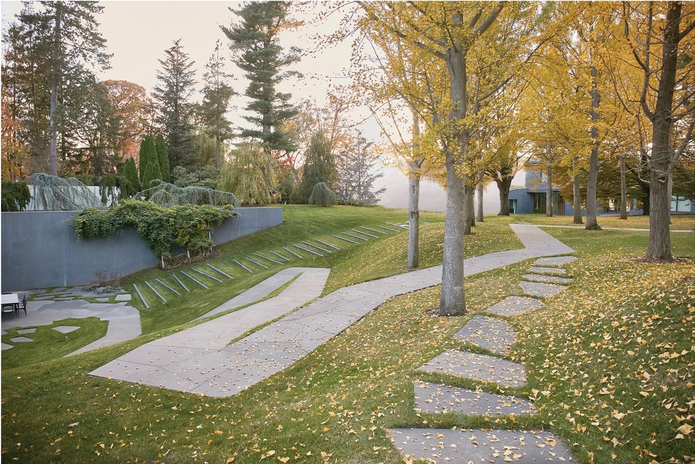 A Peaceful Park Path Lined With Trees And Grass