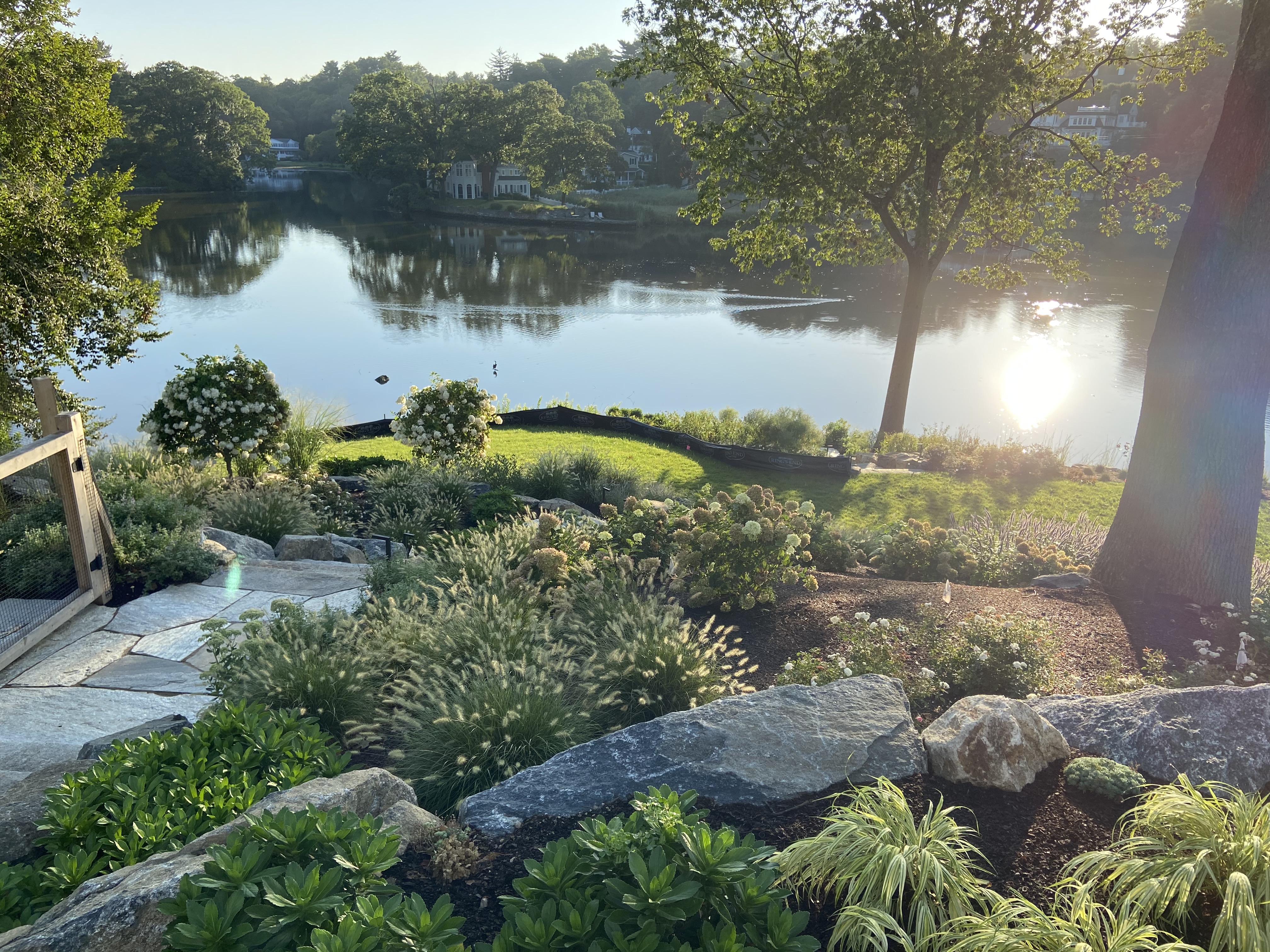 A Serene Lake Surrounded By Lush Greenery And Mountains