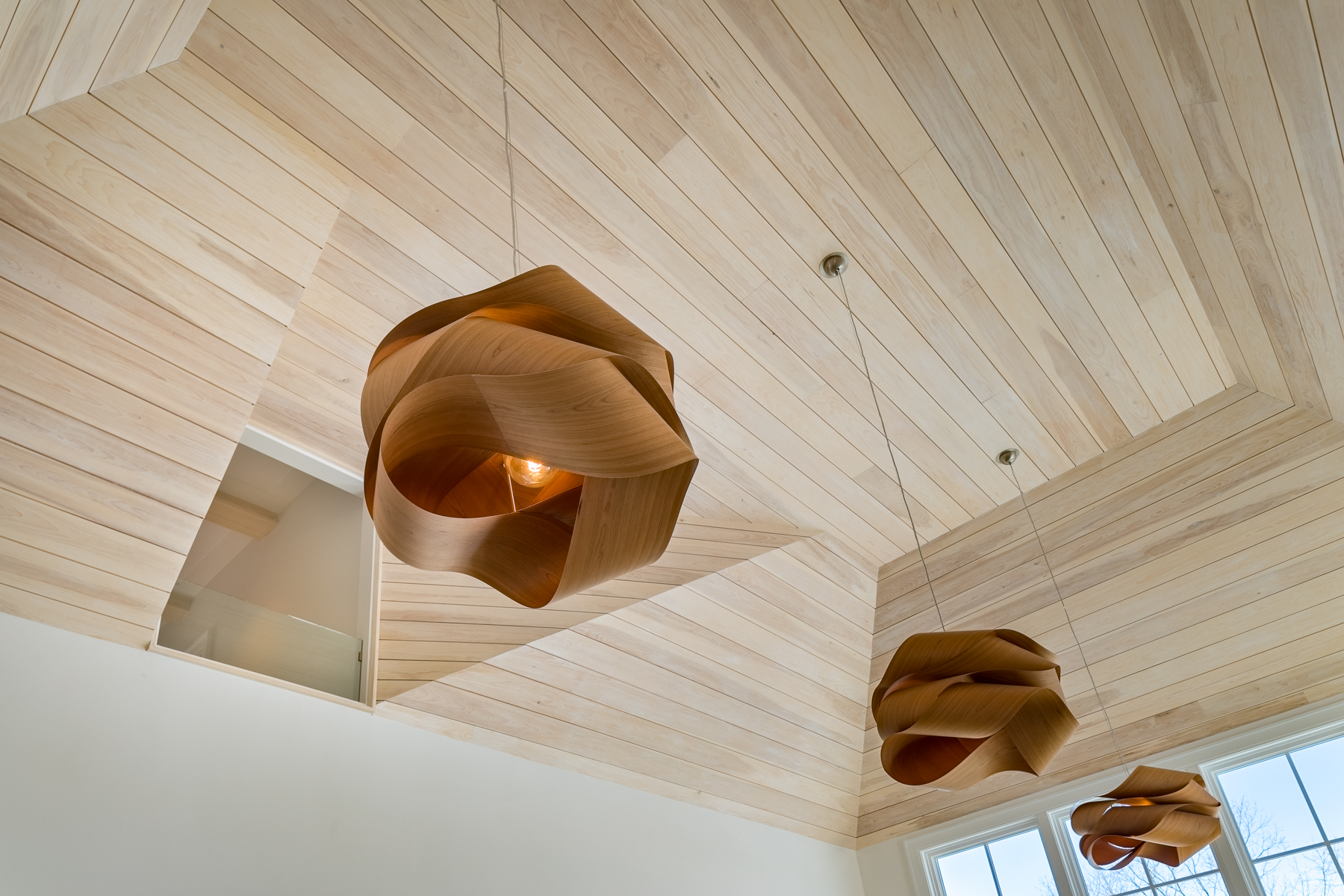 Three Wooden Pendants Suspended From The Ceiling