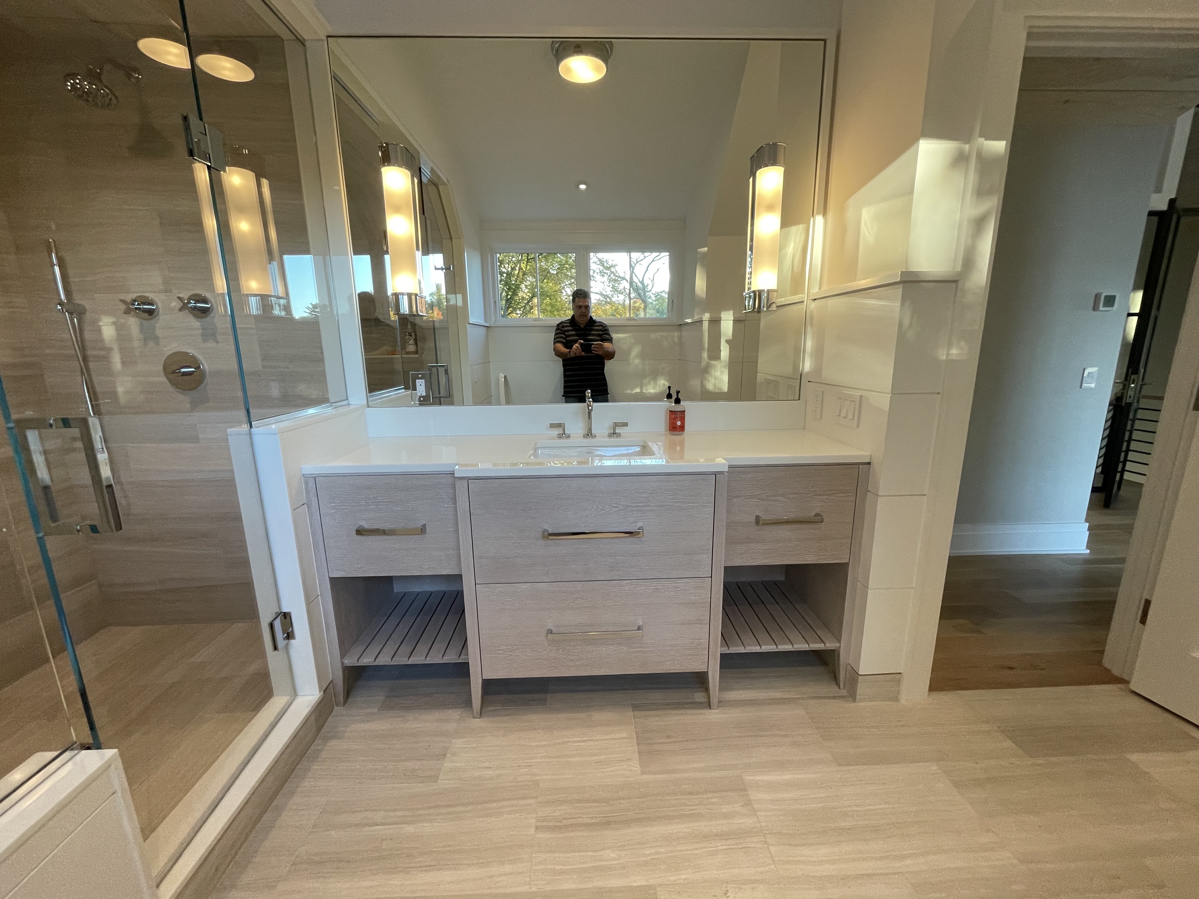 A Bathroom With A Spacious Mirror And Sink